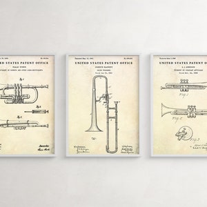 May include: Three vintage patent drawings for musical instruments. The first drawing shows a trumpet, the second shows a trombone, and the third shows a trumpet. Each drawing includes the text "United States Patent Office" and the patent number.