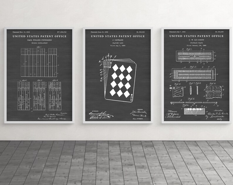 May include: Three framed patent prints on a dark gray background. The prints feature detailed white technical drawings and text, including "United States Patent Office." The middle print shows a playing card design.