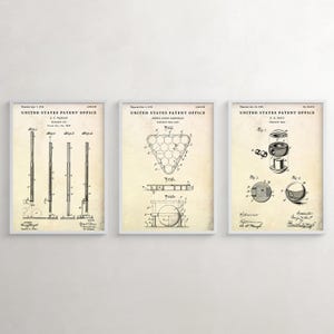 May include: Three framed vintage patent prints featuring billiard-related designs. The prints are in white frames and showcase detailed technical drawings of pool cues, billiard ball racks, and a ball cleaner, all against a cream-colored background.