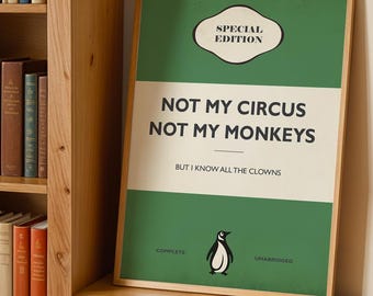 May include: A framed rectangular print with a green and cream background featuring the text "SPECIAL EDITION", "NOT MY CIRCUS NOT MY MONKEYS", "BUT I KNOW ALL THE CLOWNS", "COMPLETE", and "UNABRIDGED" along with a small illustration of a penguin.