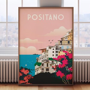 May include: A colorful poster with the text "POSITANO" in white letters on a pink background. The poster depicts a seaside town with colorful buildings, a blue sea, and pink flowers.
