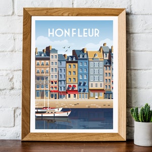 May include: A framed print of a colorful illustration of a waterfront cityscape with the text "Honfleur" at the top. The illustration features a row of colorful buildings with red roofs and a sailboat in the water.
