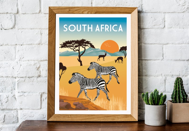 May include: A vintage travel poster featuring a sunset over a savanna landscape with zebras, antelopes, and a tree. The poster is framed in wood and has the text "SOUTH AFRICA" at the top.