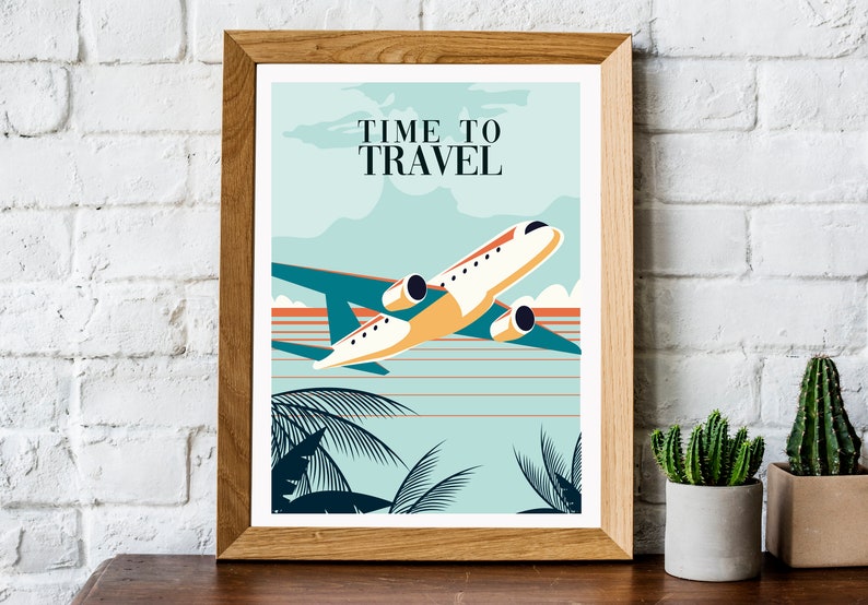 May include: A framed poster with a vintage travel theme. The poster features a white aeroplane flying over a blue and orange sunset with palm trees in the foreground. The text on the poster reads "Time to Travel".