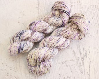 Heavy Speckled Fingering Weight Sock Yarn (75/25 Superwash Merino/ Nylon) Hand dyed in purple, brown, and hints of green on white - 100 g