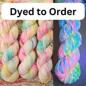 May include: Colorful hand-dyed yarn skeins in shades of pink, blue, yellow, and green. The text "Dyed to Order" is displayed on a white background. The yarn is twisted into a rope-like shape, showcasing the vibrant colors.