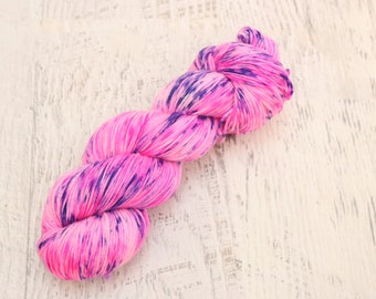 Variegated Fluorescent Fingering Weight Sock Yarn (75/25 Superwash Merino/ Nylon) Hand Dyed in Neon Pink with Blue Splotches - 100 g