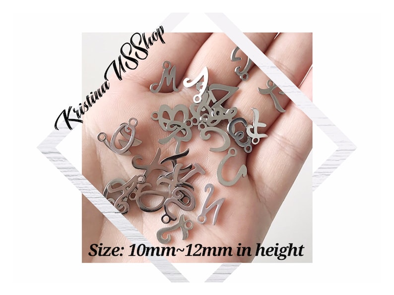 May include: A close-up of a hand holding a variety of silver metal letter charms. The charms are approximately 10mm to 12mm in height. The text "Kristina SSShop" is visible in the background.