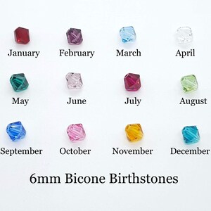 May include: Twelve 6mm bicone birthstone crystals in various colors, arranged in four rows of three crystals each. The crystals are labeled with the months of the year, from January to December.