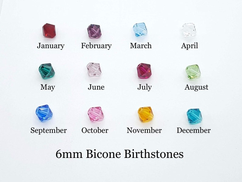 May include: Twelve 6mm bicone birthstone crystals in various colors, arranged in four rows of three crystals each. The crystals are labeled with the months of the year, from January to December.
