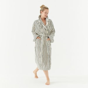 May include: A white and black striped robe with a shawl collar and a tie belt. The robe has two pockets.