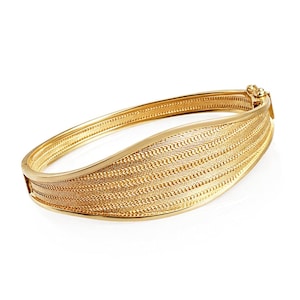 Brazalete articulado de oro texturizado