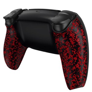 May include: A black video game controller with red and black patterned grips. The controller has a textured surface and is designed for use with a gaming console.