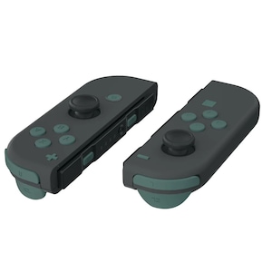 May include: Two black Nintendo Switch Joy-Con controllers with teal buttons and face buttons. The controllers are in a neutral position, with the left controller facing the camera and the right controller facing away from the camera.