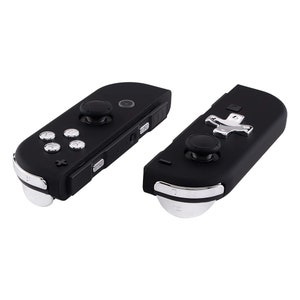 May include: Two black Nintendo Switch controllers with custom buttons. One controller has a silver plus button and the other has a silver directional pad.
