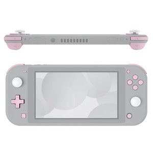 Może przedstawiać: Szara przenośna konsola do gier Nintendo Switch Lite z różowymi przyciskami i białym ekranem. Konsola jest w orientacji poziomej.