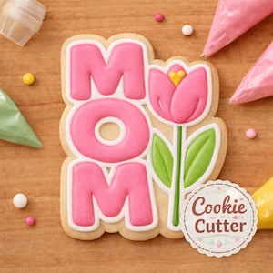 May include: A Mother's Day cookie cutter in the shape of the word "MOM" with a pink tulip. The cookie is decorated with pink icing and white outlines. The image includes sprinkles and piping bags.