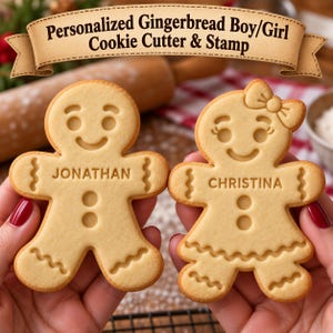 May include: Two light tan gingerbread cookies shaped like a boy and a girl. The boy cookie is embossed with the name JONATHAN and the girl cookie is embossed with the name CHRISTINA. Both feature smiling faces, circular eyes, and wavy lines.