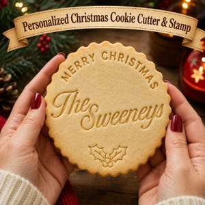 May include: A round, scalloped-edge cookie featuring the embossed text Merry Christmas and The Sweeneys, with a holly leaf design at the bottom. Above the cookie, a tan banner displays the text Personalized Christmas Cookie Cutter & Stamp.