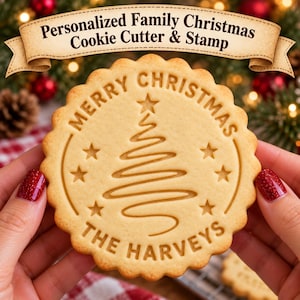 May include: A round, scalloped-edge cookie featuring an embossed design of a stylized Christmas tree, stars, and the text Merry Christmas The Harveys. The cookie is light golden brown with a smooth, baked texture and clear, crisp impressions.
