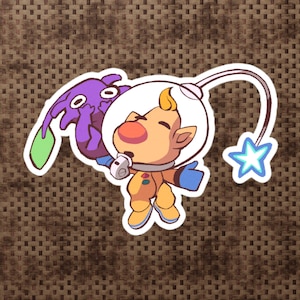 May include: A cartoon character wearing a yellow spacesuit and a helmet with a purple creature attached to the side. The character is holding a star in its hand.