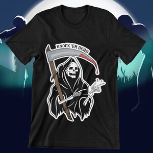 May include: Black t-shirt with a graphic of the Grim Reaper holding a scythe and giving a peace sign. The text "Knock 'em Dead" is above the graphic.