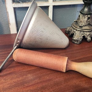 vintage aluminum cone sieve and wood pestle