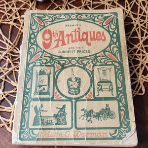 May include: A vintage book titled "Warman's 9th Antiques and their Current Prices." The cover features illustrations of antique items in a green, red, and cream color scheme. The book is slightly worn, suggesting its age.