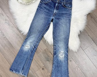 XS/24 Vintage años 70 746 Lavado oscuro Etiqueta naranja Ajuste entallado Corte bota Pierna acampanada Levis