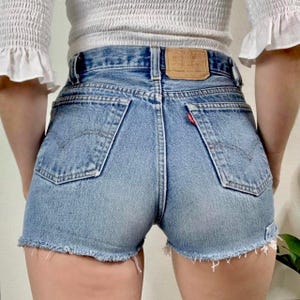 XS/25 Vintage 80s 701 Medium Wash Patchwork Levis Cutoff Shorts