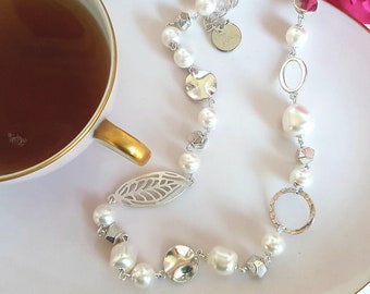 A modern twist on the classic pearl necklace with Swarovski pearls and skeleton leaf feature piece.