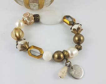 Beaded bracelet of Swarovski pearls, magnesite, glass, dolomite and featured Kashmiri bead.