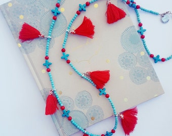 Long boho-inspired necklace of magnesite gemstones and cotton tassels.