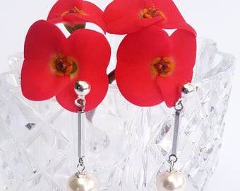 Classic Swarovski pearl drop earrings on stainless steel studs.