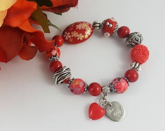 Red bracelet featuring howlite. magnestite, riverstone gemstone natural beads with glass Kashmiri bead feature and heart charm