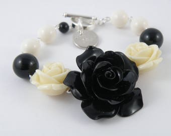Retro-inspired resin rose bracelet in ivory and black.