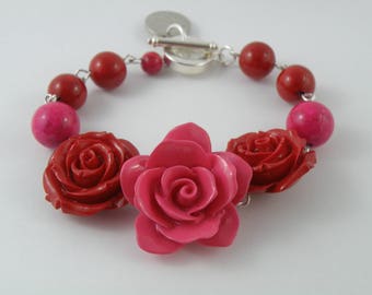 Retro-inspired resin rose bracelet in pink and red.
