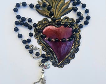 Long necklace of black riverstone gemstone with affirmation ring and tassel.