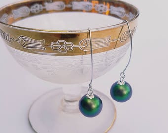 Scarabeus green Swarovski pearl earrings on long sterling silver hooks.