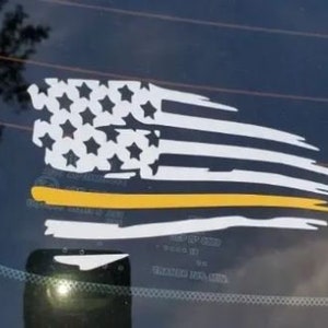 May include: A white and yellow distressed American flag decal with a thin yellow stripe across the middle. The flag is on a dark blue background.