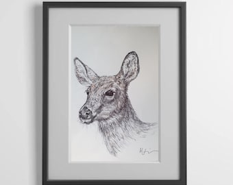 May include: Framed pen and ink drawing of a deer's head and neck, rendered in shades of gray and brown. The artwork is set against a white background, framed in a black frame. The deer is depicted in profile, with detailed fur and large ears.