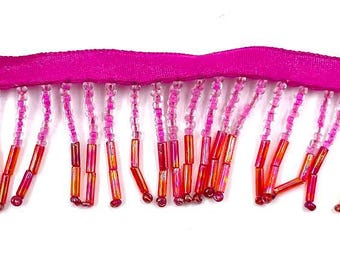 May include: Pink and orange beaded fringe trim with a pink satin ribbon backing.