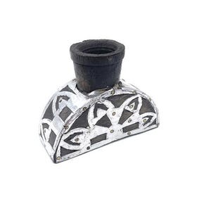 May include: A black and silver decorative wooden inkwell with a Celtic knot design.