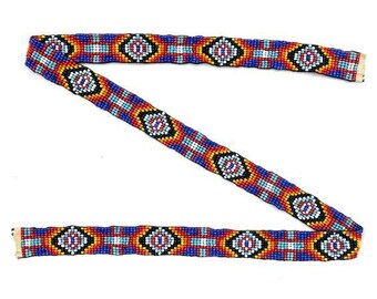 May include: A beaded trim with a geometric pattern in shades of blue, red, orange, white, and black.