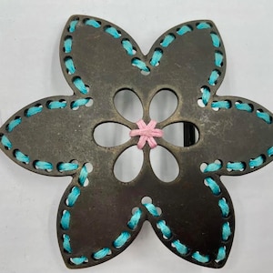 flower shaped old brass belt buckle with turquoise and pink colored threading