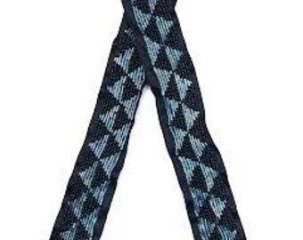 May include: A black fabric headband with a repeating pattern of white triangles.