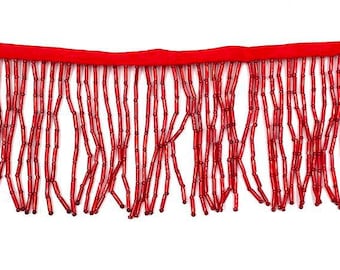 May include: Red beaded fringe trim. The fringe is made of small, round beads that are strung together to create a long, flowing fringe. The fringe is attached to a red fabric backing.