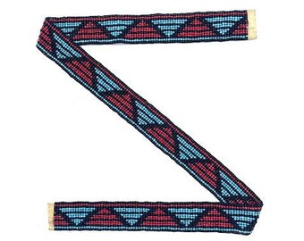 May include: A beaded trim with a geometric pattern in shades of blue, red, and black. The trim has a gold edge.
