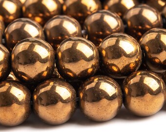 May include: A strand of round, metallic gold beads. The beads are smooth and shiny, with a slight textured surface.