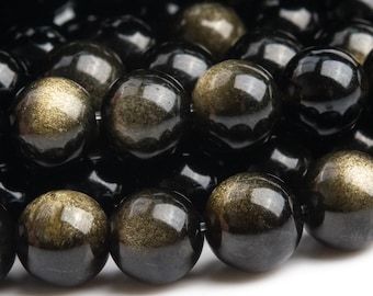 May include: A strand of black and gold gemstone beads. The beads are round and have a smooth, polished finish. The gold flecks in the beads create a shimmering effect.